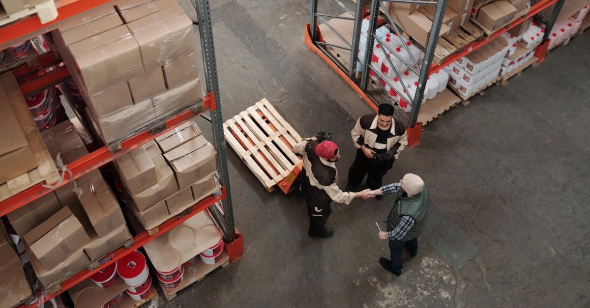 people shaking hands in a warehouse